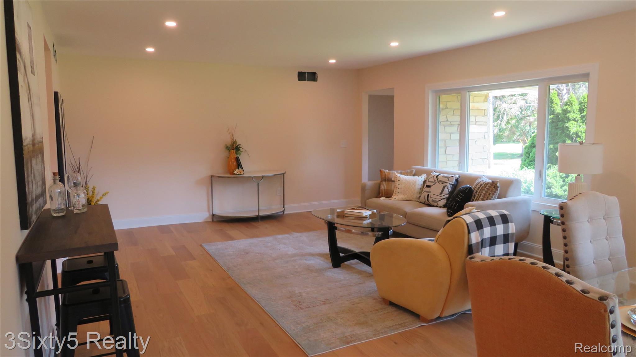 16558 Haggerty Road Belleville, MI 48111 - Photo 7 of 40 Spacious living area featuring light wood-finish flooring, recessed lighting, and a large window