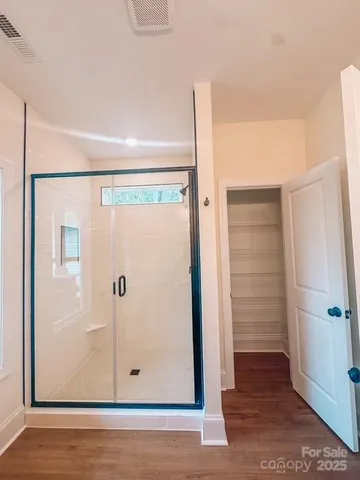 a bathroom with a glass shower door