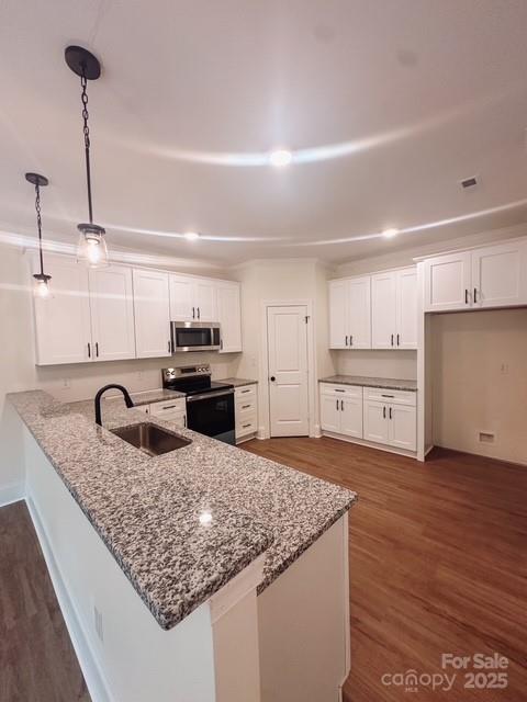 720 McLarty Street Monroe, NC 28112 - Photo 5 of 14 a kitchen with stainless steel appliances granite countertop a sink stove and cabinets