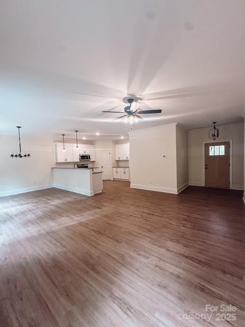 720 McLarty Street Monroe, NC 28112 - Photo 8 of 14 a view of a big room with wooden floor and windows