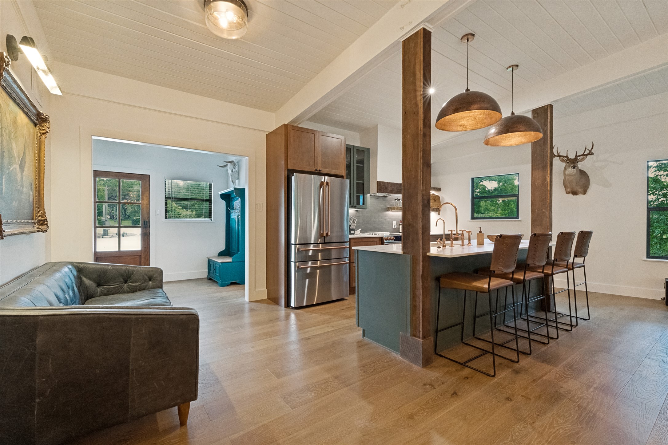 303 Lago Verde Road Austin, TX 78734 - Photo 8 of 39 Natural light floods this inviting space, highlighting the kitchen island with ample seating.