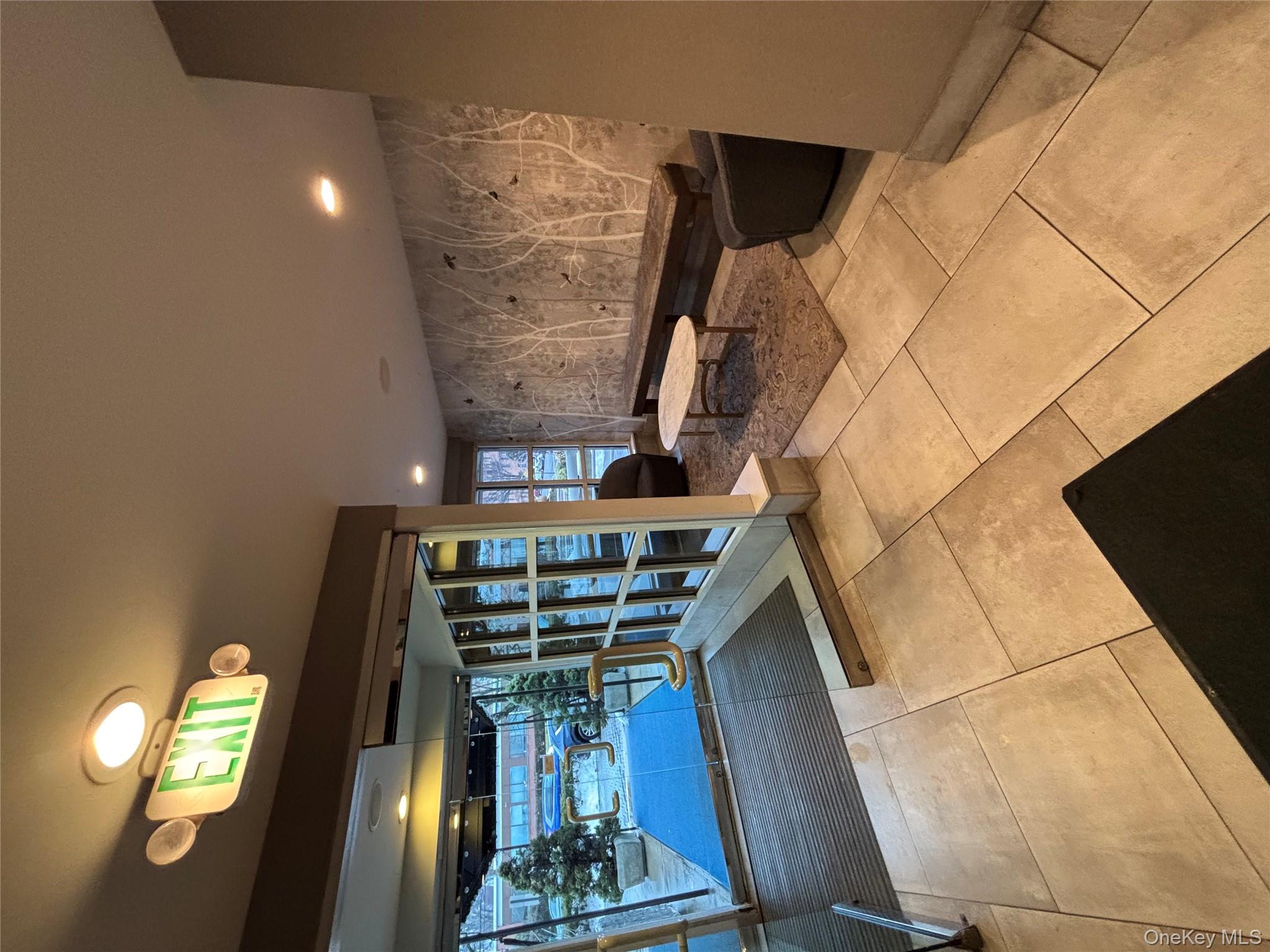 100 Cutter Mill Road, Unit 1B Great Neck, NY 11021 - Photo 15 of 16 a lobby with furniture and chandelier