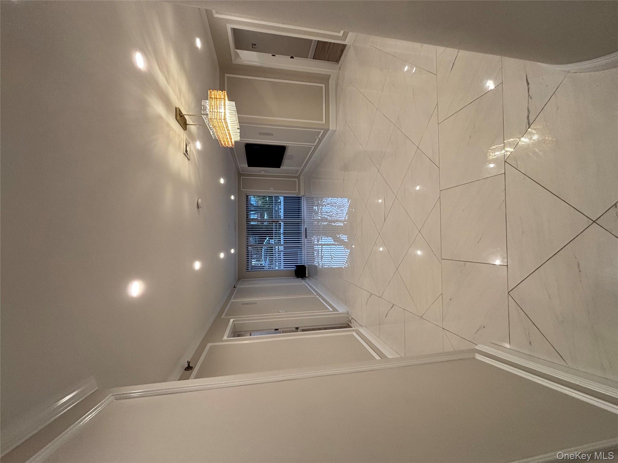 100 Cutter Mill Road, Unit 1B Great Neck, NY 11021 - Photo 3 of 16 a view of a hallway with seating area