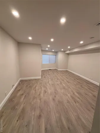 a view of an empty room and a wooden floor