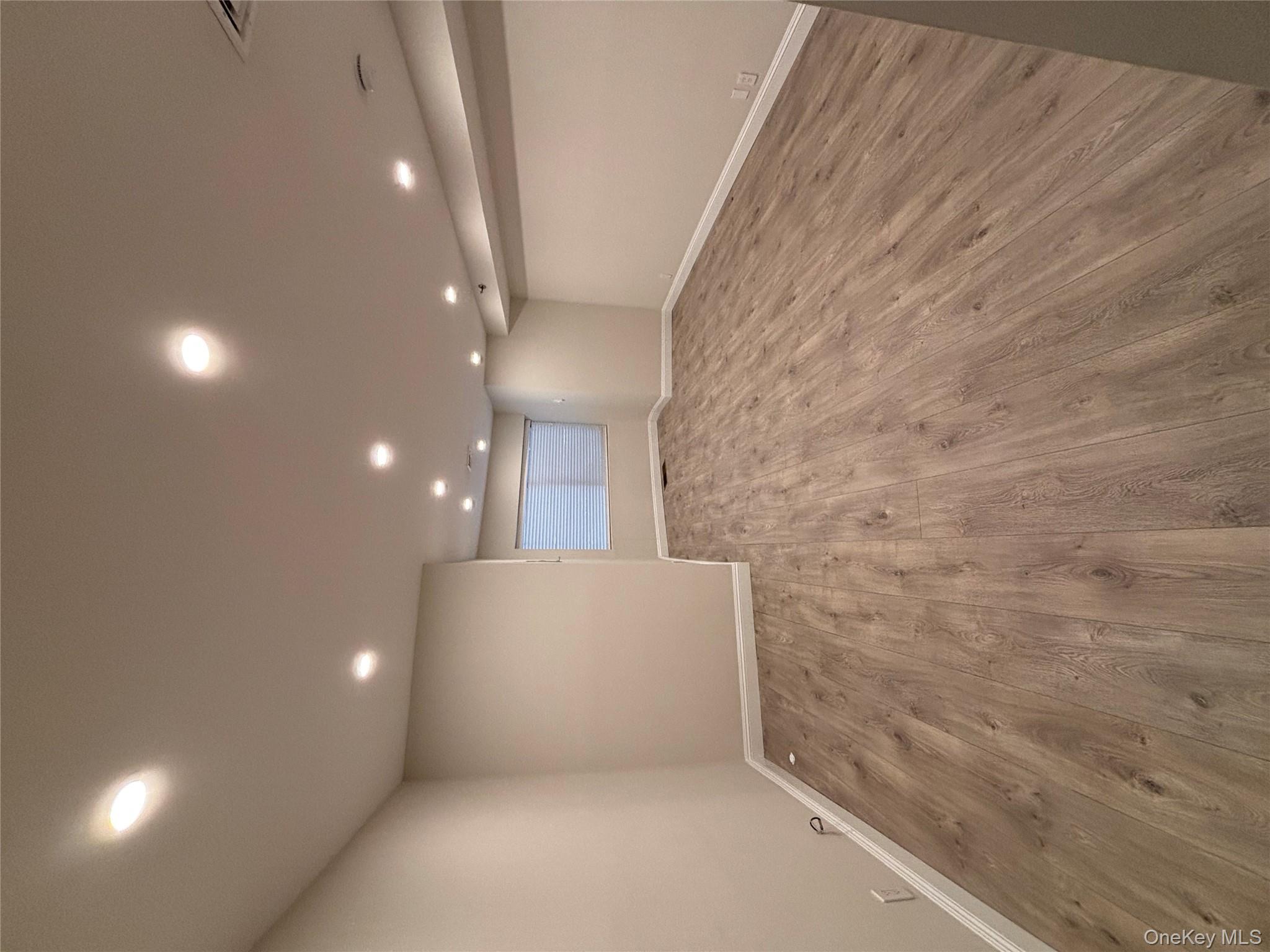 100 Cutter Mill Road, Unit 1B Great Neck, NY 11021 - Photo 4 of 16 a view of a room with wooden floor