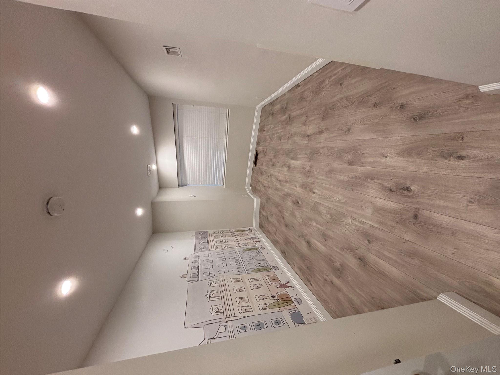 100 Cutter Mill Road, Unit 1B Great Neck, NY 11021 - Photo 5 of 16 a view of an empty room and a wooden floor