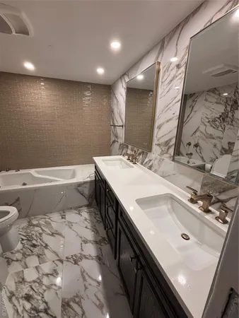 a bathroom with a sink a toilet and vanity