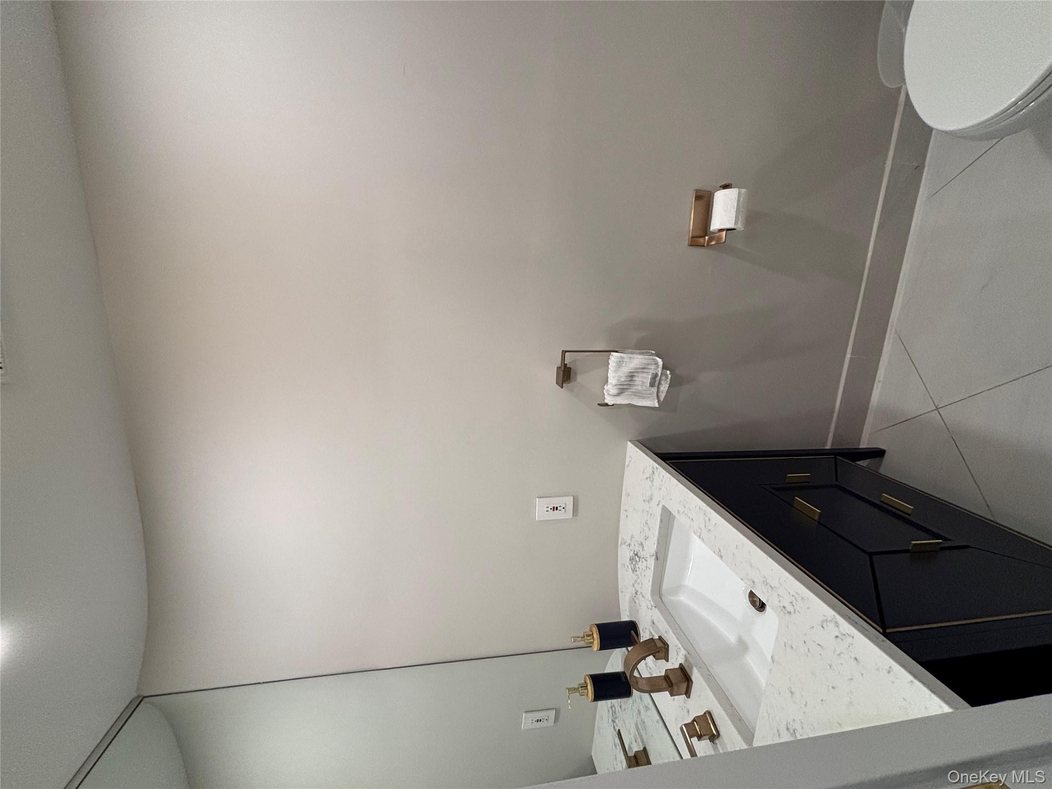 100 Cutter Mill Road, Unit 1B Great Neck, NY 11021 - Photo 10 of 16 a bathroom with a sink a toilet and vanity