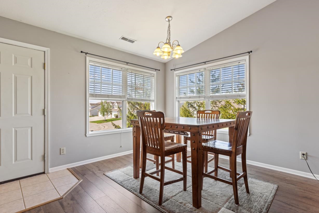 12000 Primrose Place Poplar Grove, IL 61065 - Photo 15 of 15 a view of a dining room with furniture a chandelier and wooden floor