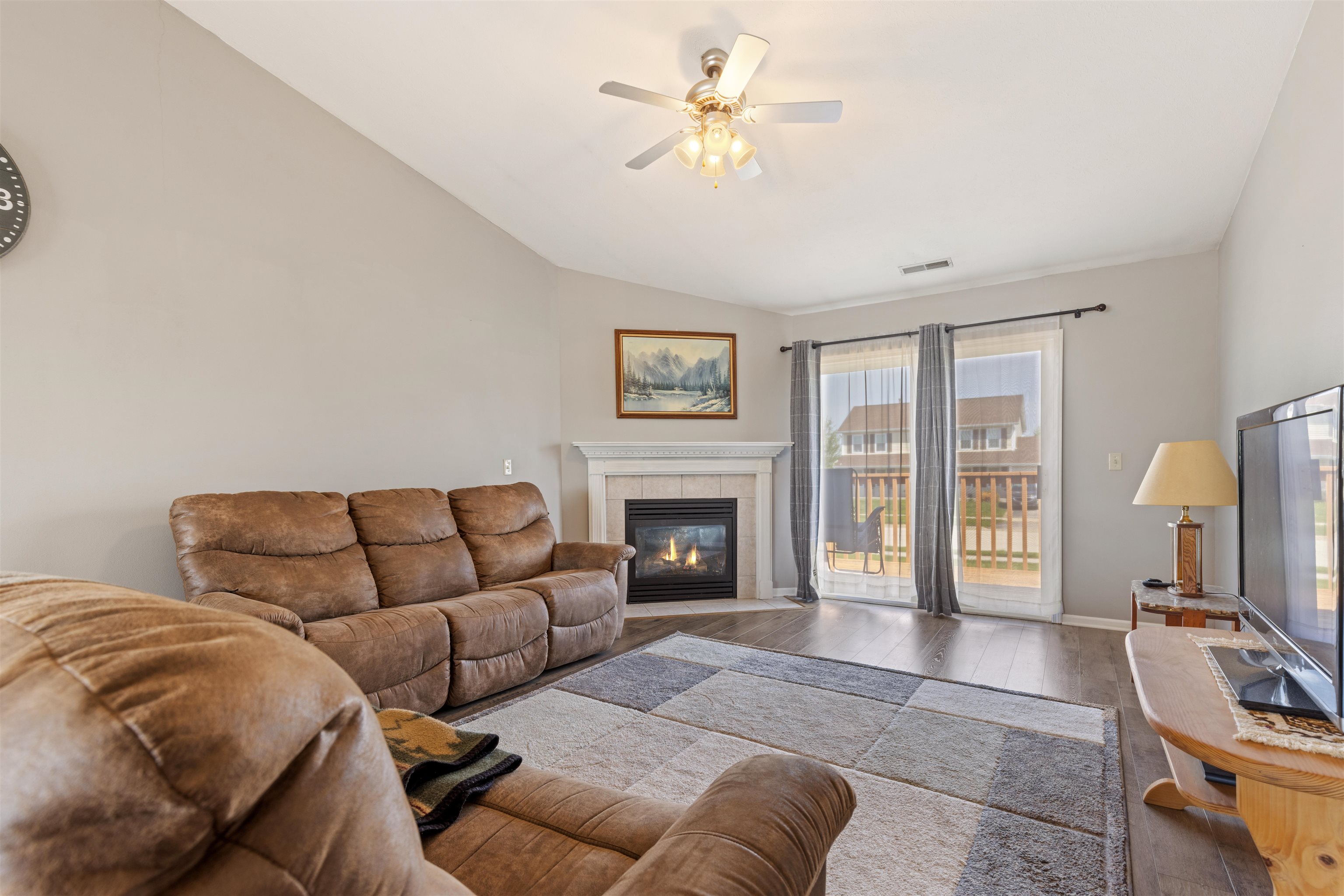 12000 Primrose Place Poplar Grove, IL 61065 - Photo 2 of 15 a living room with furniture ceiling fan and a fireplace