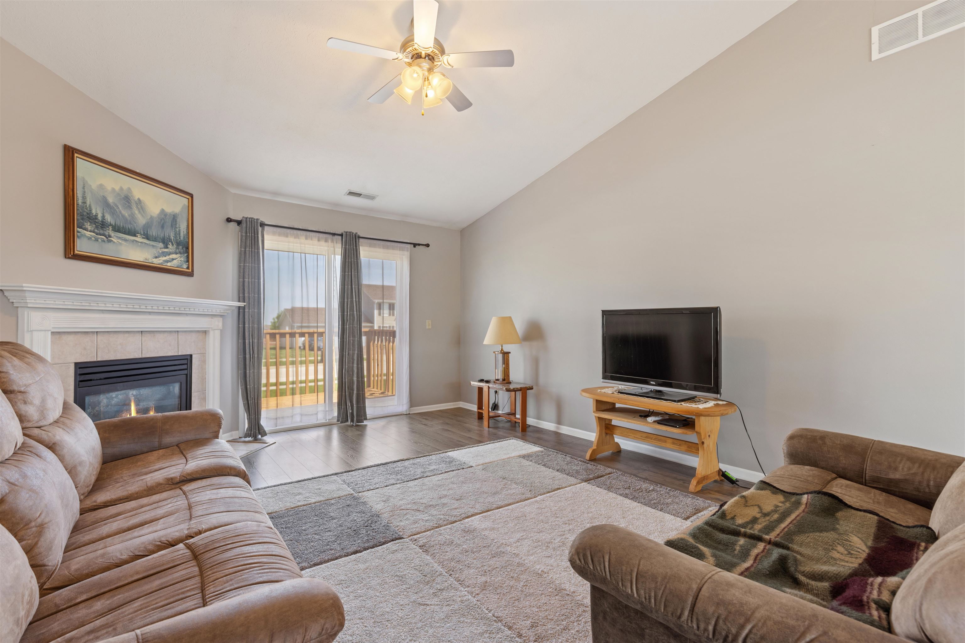 12000 Primrose Place Poplar Grove, IL 61065 - Photo 3 of 15 a living room with furniture a fireplace and a flat screen tv