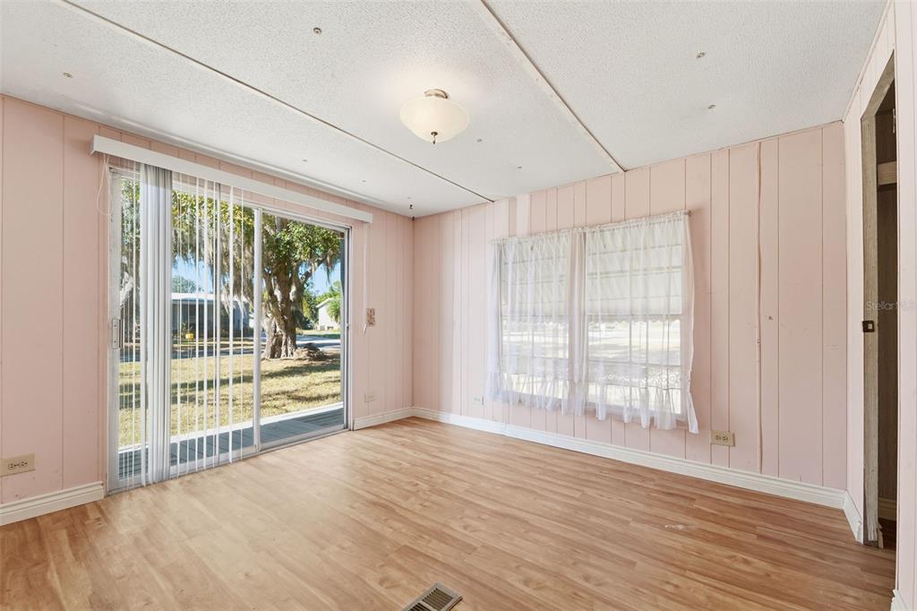 19 Mary Bell Landing Road Sebring, FL 33876 - Photo 13 of 22 a view of an empty room with wooden floor and a window