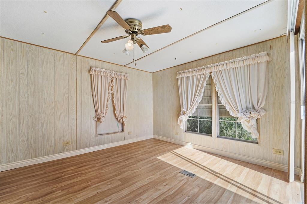 19 Mary Bell Landing Road Sebring, FL 33876 - Photo 15 of 22 an empty room with wooden floor fan and windows