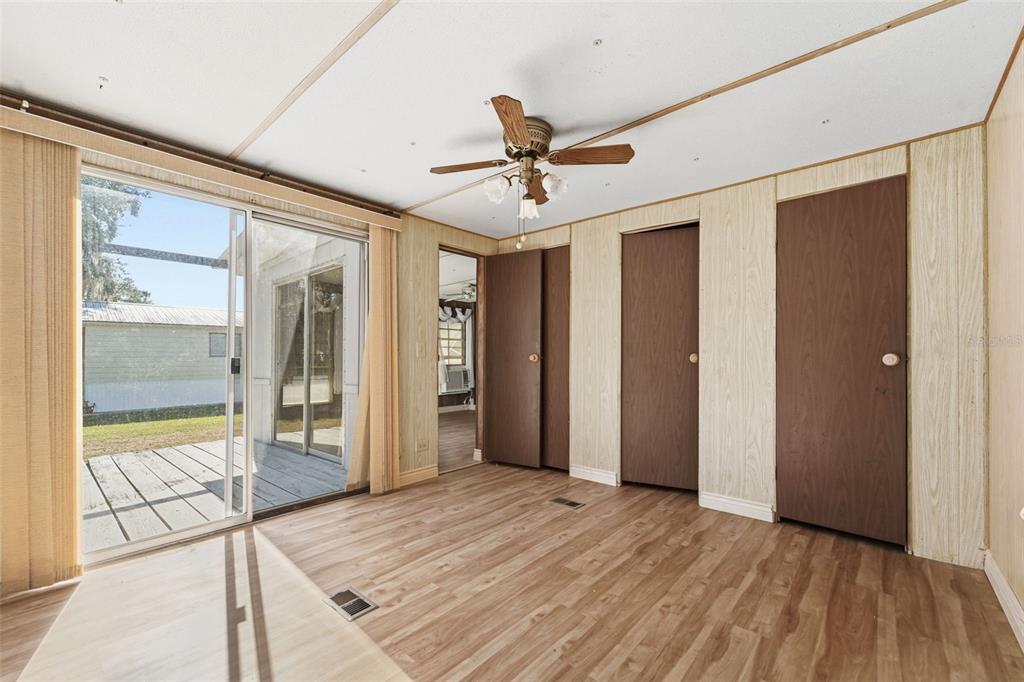 19 Mary Bell Landing Road Sebring, FL 33876 - Photo 16 of 22 a view of a livingroom with wooden floor and a ceiling fan
