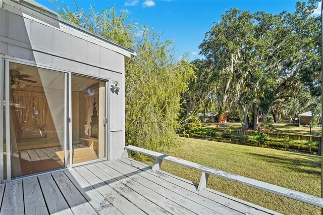 a view of backyard with tub and trees in the background