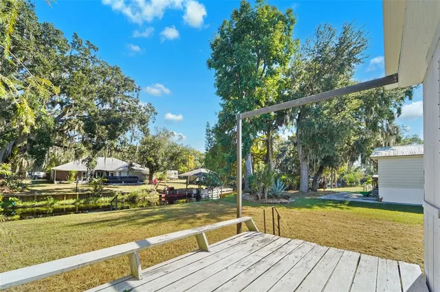 a view of a swimming pool with a patio and a yard