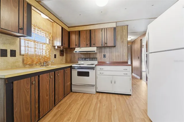a kitchen with white cabinets and white appliances