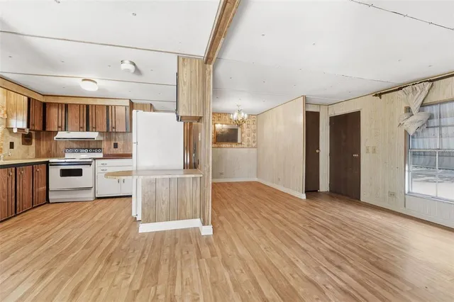 a view of kitchen with cabinets and wooden floor