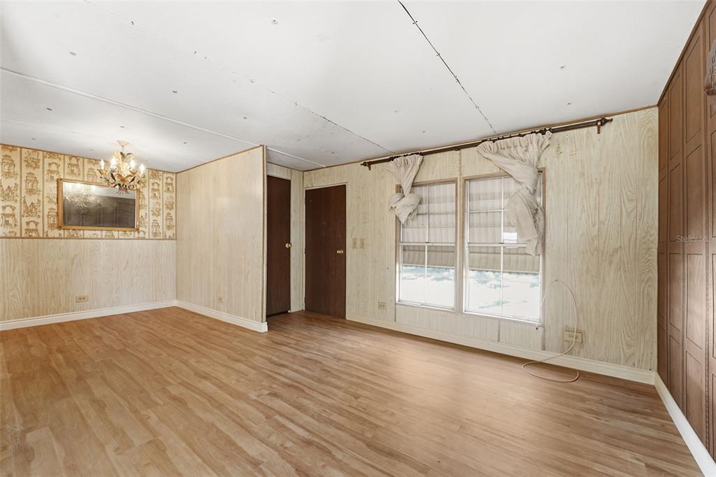 19 Mary Bell Landing Road Sebring, FL 33876 - Photo 9 of 22 a view of empty room with wooden floor and fan