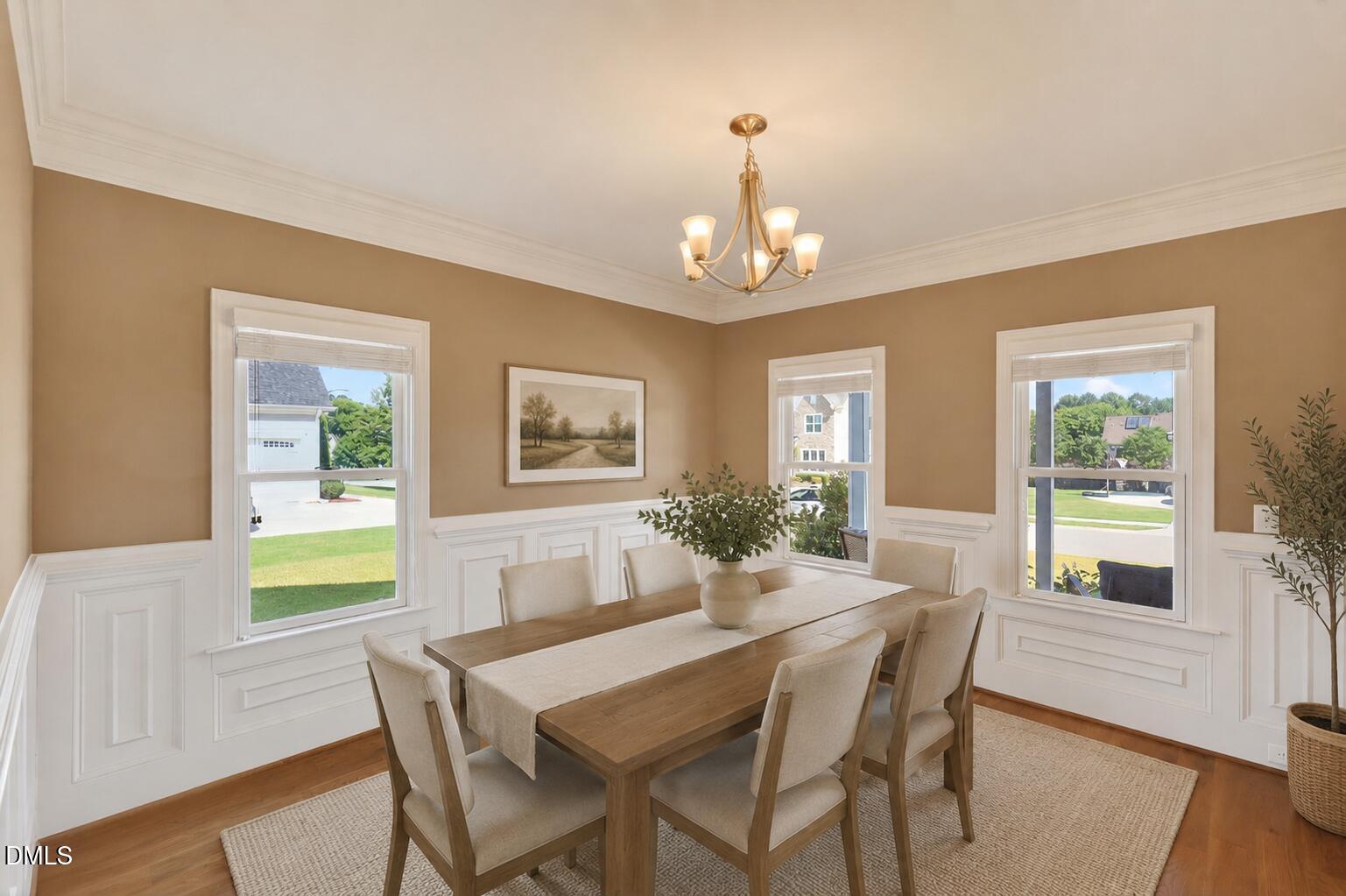 261 Character Drive Rolesville, NC 27571 - Photo 10 of 77 a view of a dining room with furniture a chandelier and wooden floor