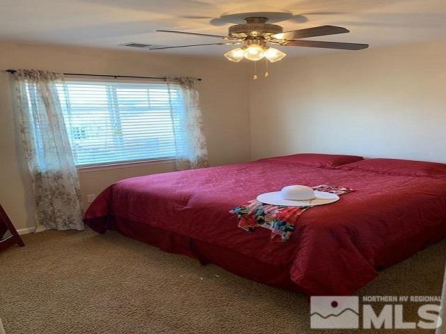 8920 Yeager Street Reno, NV 89506 - Photo 18 of 21 a bedroom with a bed and a chandelier