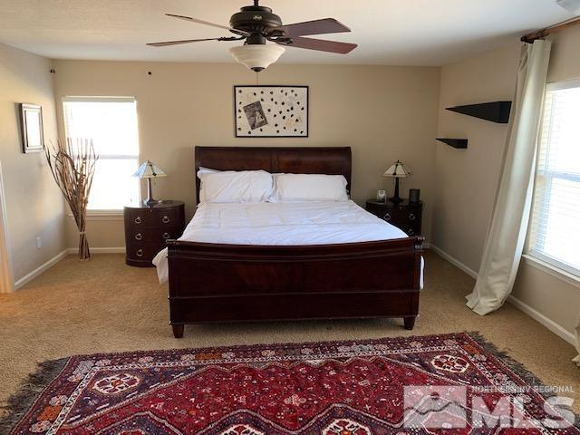 8920 Yeager Street Reno, NV 89506 - Photo 10 of 21 a bedroom with a bed rug and wooden floor