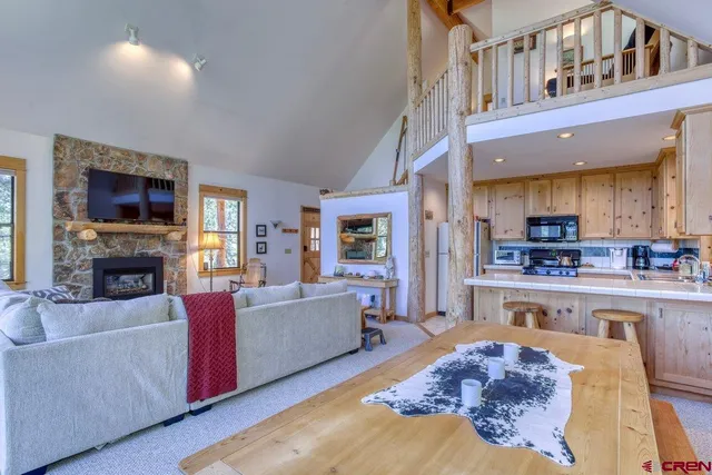 a living room with fireplace furniture and a flat screen tv