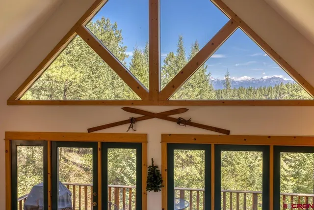 a bed sitting in a spacious bedroom next to a window