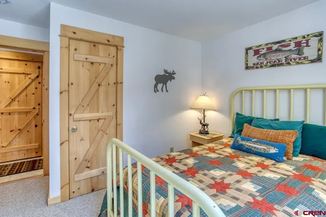 a bedroom with a bed and a book shelf