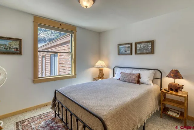 a view of a livingroom with wooden furniture