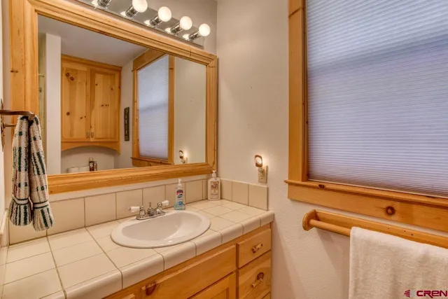 a view of a hallway to a livingroom with furniture