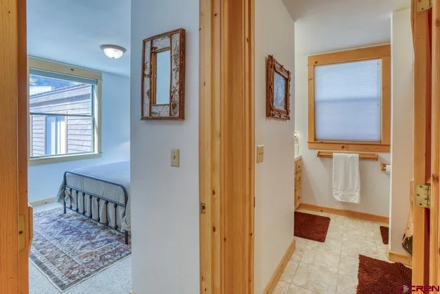 a view of a house with a yard and large trees