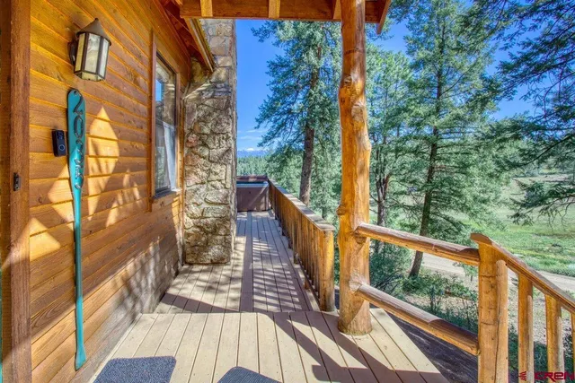 a view of a balcony with wooden floor and fence