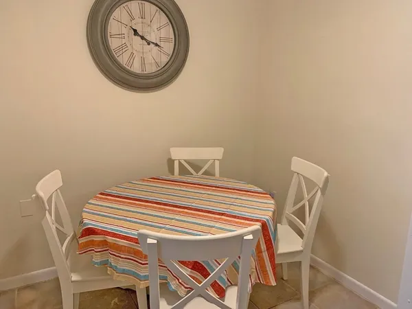a bedroom with a table and a chair