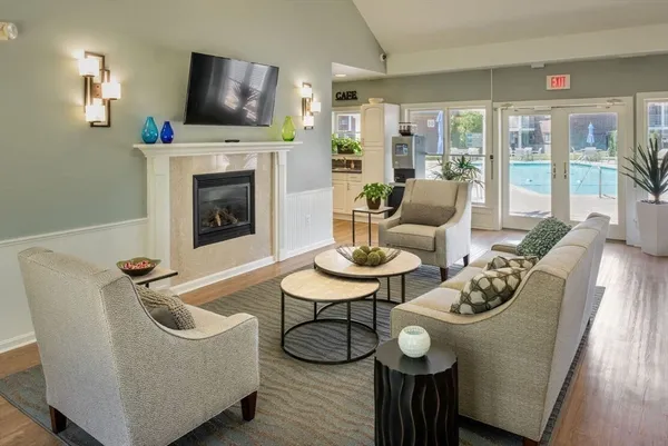 a living room with furniture a fireplace and a flat screen tv