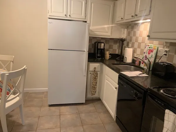 a kitchen with a sink appliances and cabinets