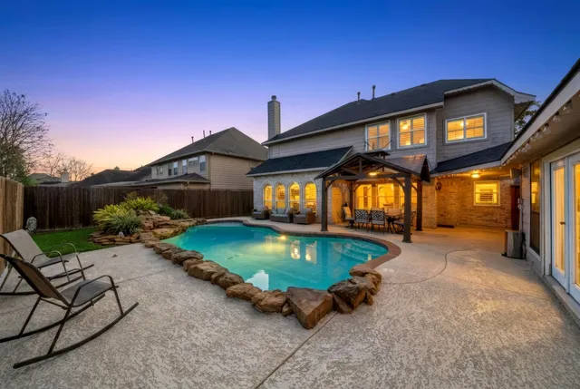 a view of a house with backyard porch and sitting area