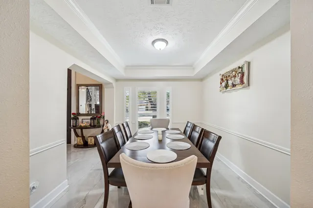 a living room with furniture ceiling fan and a window