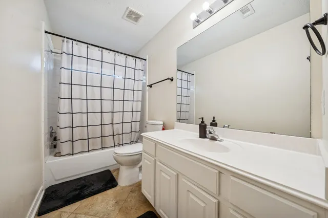 a spacious bathroom with a double vanity sink mirror and shower
