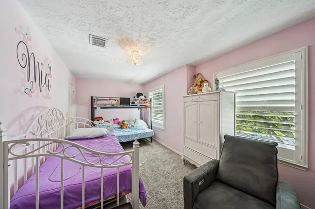 a front view of a house with patio and a yard