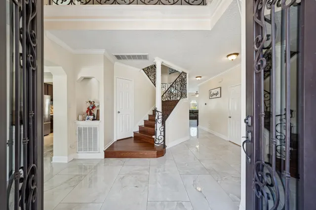 a kitchen with stainless steel appliances kitchen island granite countertop a refrigerator a stove and a sink