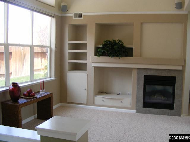 9629 Truckee Meadows Place Reno, NV 89521 - Photo 5 of 8 a living room with a fireplace and a window
