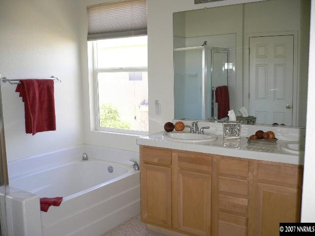 9629 Truckee Meadows Place Reno, NV 89521 - Photo 8 of 8 a bathroom with a tub sink and mirror
