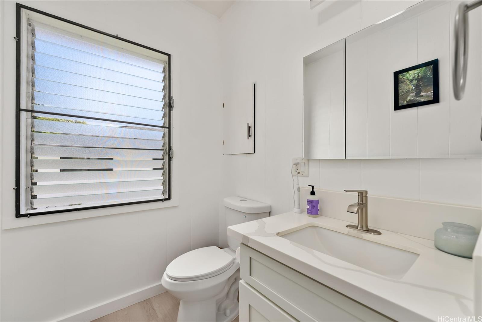 2811 Henry Street Honolulu, HI 96817 - Photo 13 of 25 Get ready in style! This crisp, clean bathroom features modern fixtures, wonderful lighting, and classic jalousie windows.