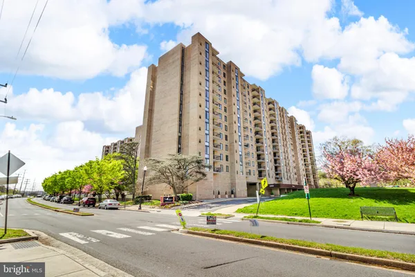 a view of a tall building next to a road