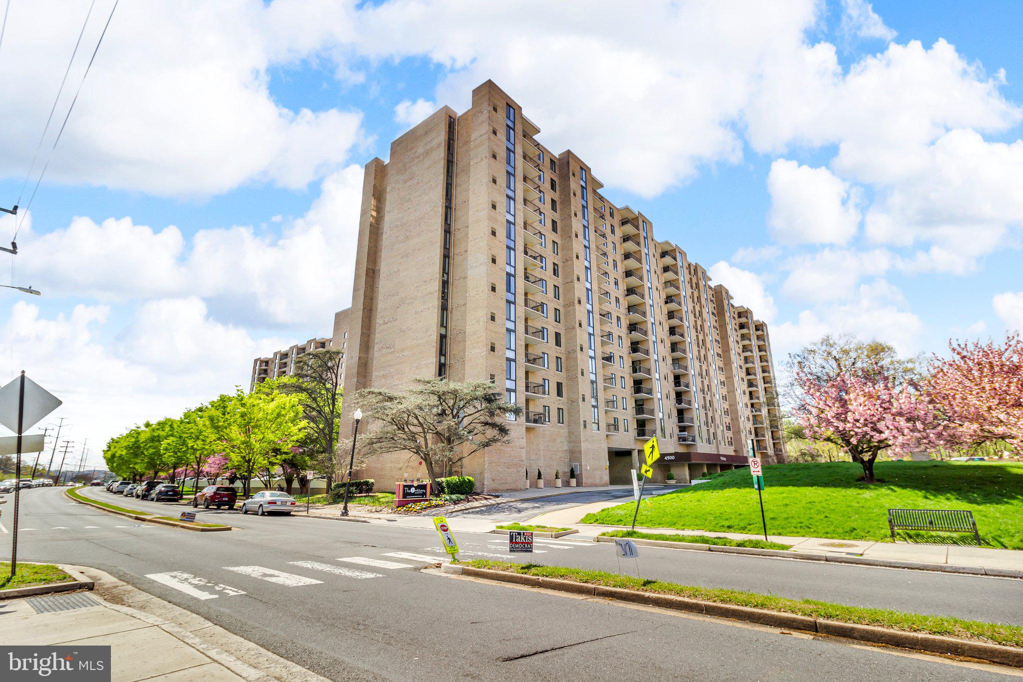 a view of a tall building next to a road