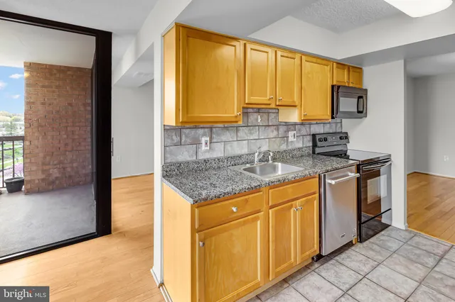 a kitchen with a sink refrigerator and microwave