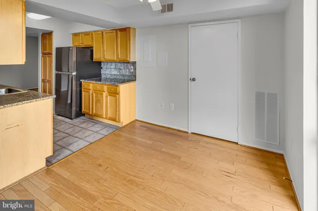 a kitchen with stainless steel appliances granite countertop a sink and cabinets