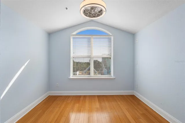 a view of a room with wooden floor and a window