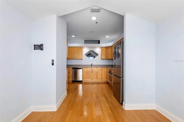 a view of a hallway with wooden floor and staircase